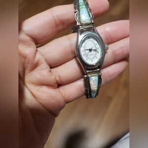 Navajo cultured opal set in sterling silver, a quartz movement, and a silver sta